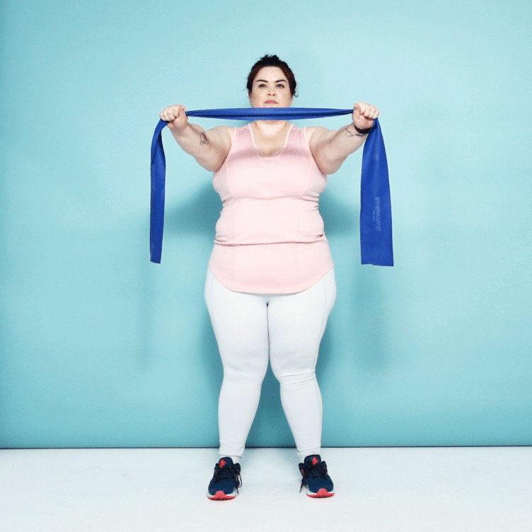 Woman demonstrating a pull-apart with a resistance band