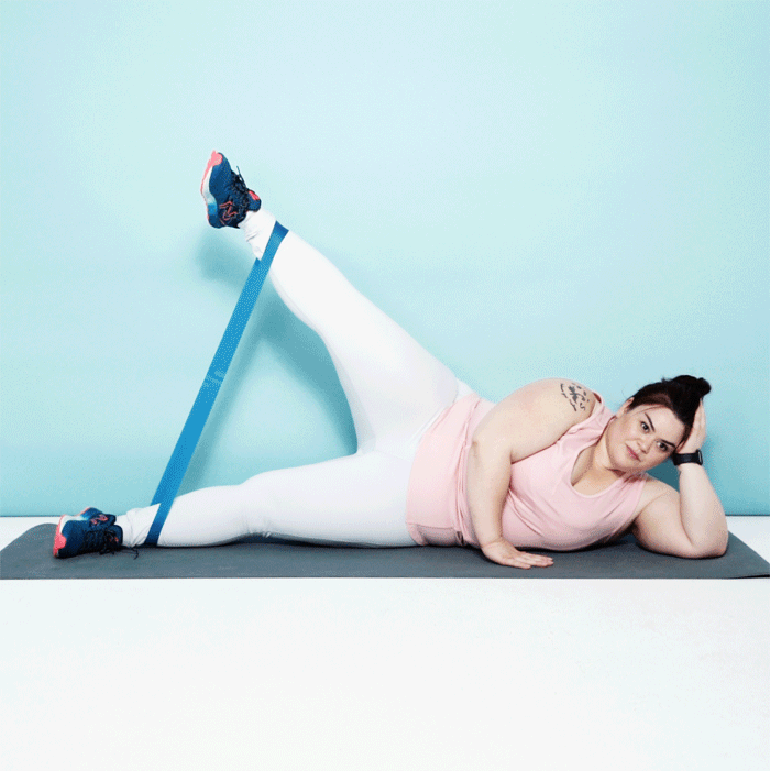 Woman demonstrating a leg raise/abduction with a resistance band